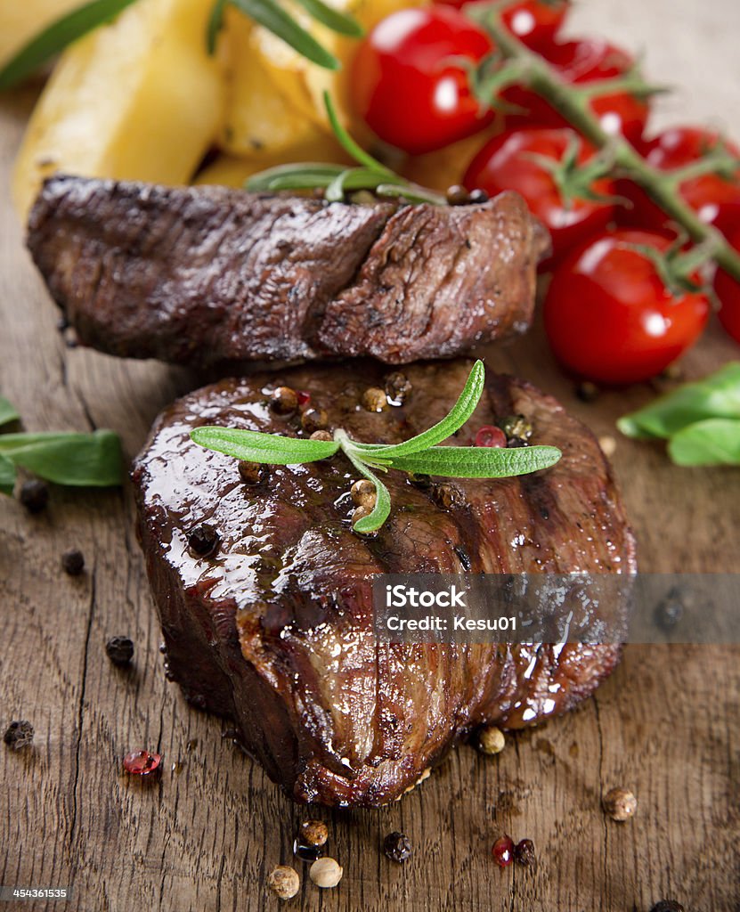 Delicious beef steak Delicious beef steak on wooden table Barbecue - Meal Stock Photo