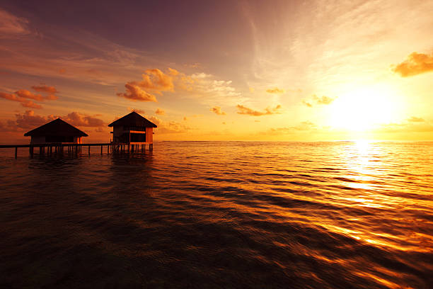 istock maldivian houses on sunrise 454363019