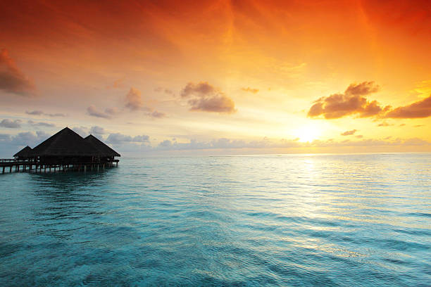 istock maldivian houses on sunrise 454363021