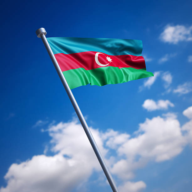 flagge von aserbaidschan vor blauem himmel - azerbaijan flag stock-fotos und bilder