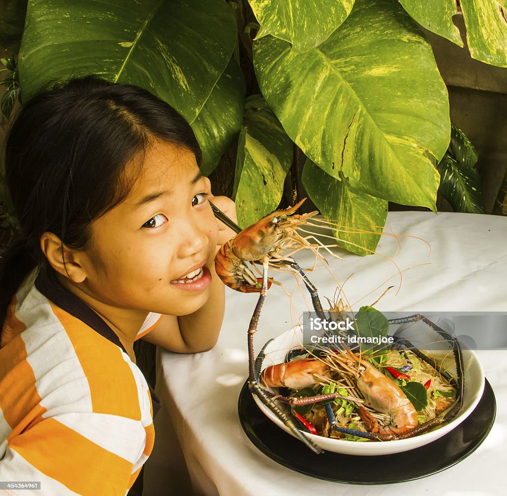 Steamed shrimps with glass noodles Asian girl eating steamed shrimps with glass noodle on the table. Appetizer Stock Photo