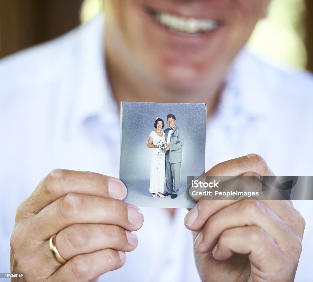 The day we got married... Cropped image of a person holding up an old wedding photo Old Stock Photo