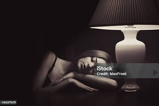 Low Key Sepia Portrait Of Sleeping Near The Lamp Woman Stock Photo - Download Image Now