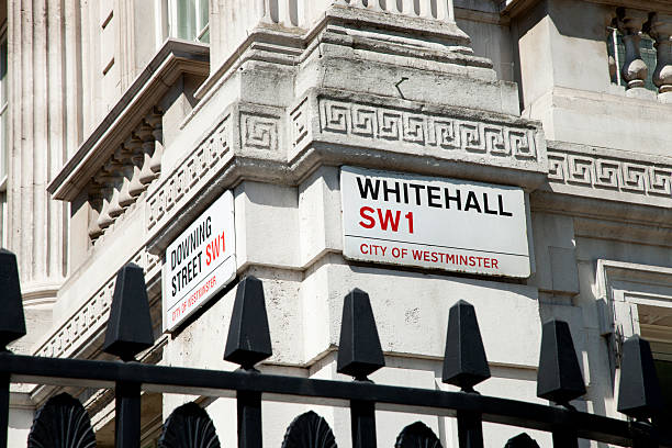 Street signs on the corner of Downing Street and Whitehall.  Downing Street is the home of the British Prime Minister and government.