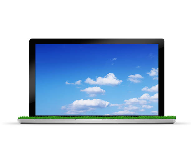 istock laptop with blue sky and green grass 454375463