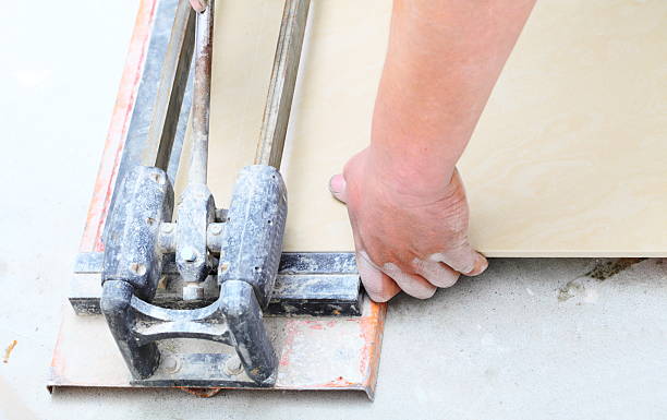 istock Construction worker is cutting tiles at home, renovation 454378337