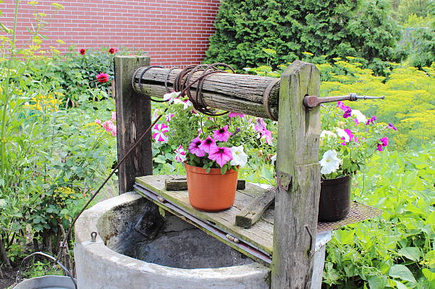 Wooden aqueduct from stream, irrigation and delivery of water through wooden trough, quenching thirst on hot day