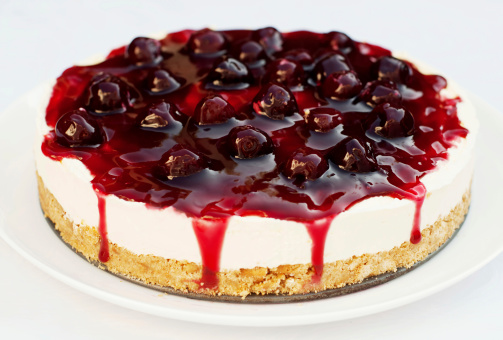 Homemade Cheesecake with cherries, cherry topping and mascarpone cream.
