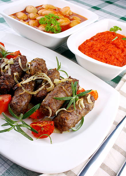 istock Grilled meat rolls with giant white beans and sauce 454398755