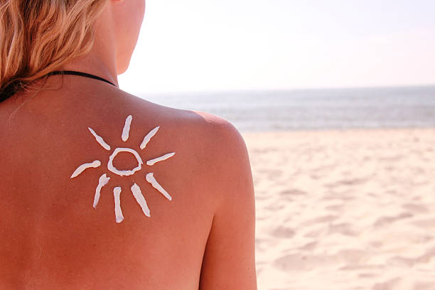 istock sun cream on the female back 454402059
