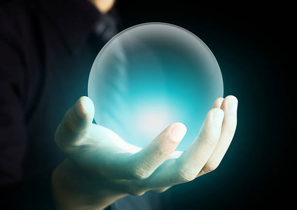 Hand holding a glowing crystal ball