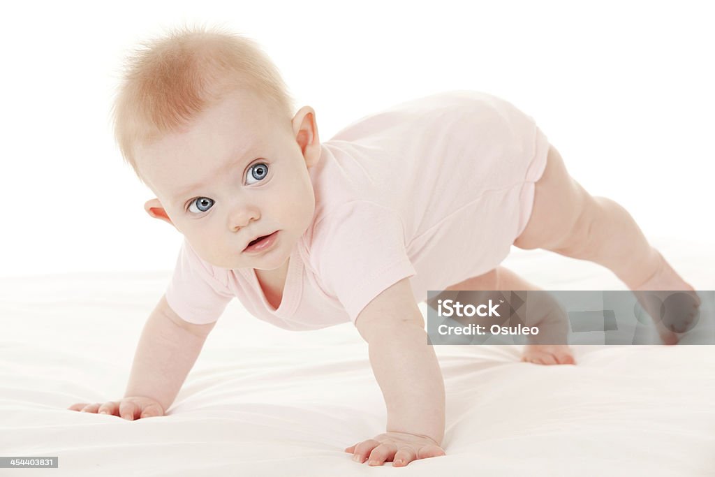 Cute baby with beautiful blue eyes on the white bed Baby - Human Age Stock Photo