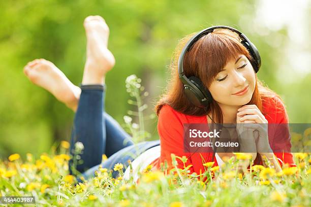 Happy Woman With Headphones Relaxing In The Park Stock Photo - Download Image Now - Adult, Adults Only, Audio Equipment