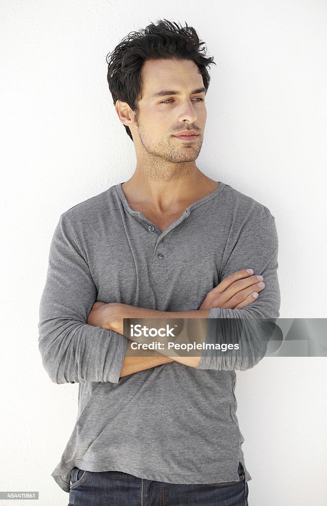 Looking confident A handsome young man standing with his arms folded confidently 20-29 Years Stock Photo