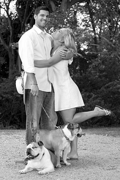 istock happy couple with dogs 454413269