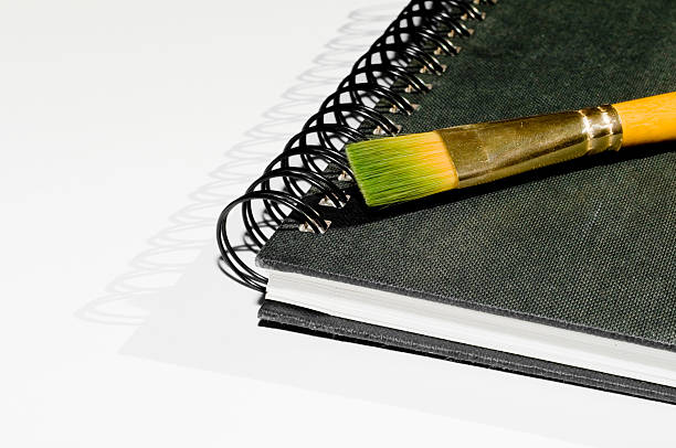 Black notebook with paintbrush stock photo