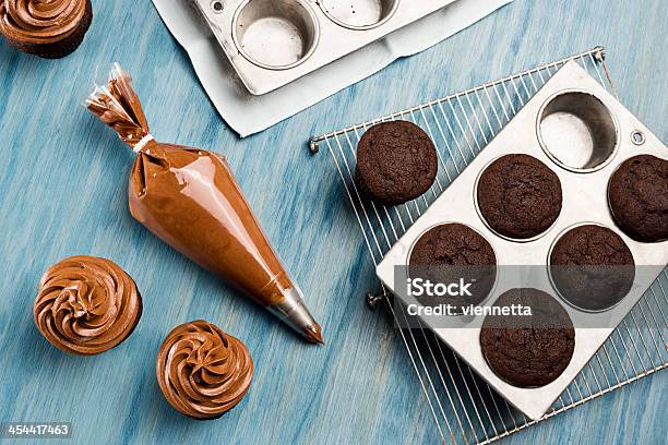 Decorating Chocolate Cupcakes With Frosting Stock Photo - Download Image Now - Icing Bag, Blue, Chocolate