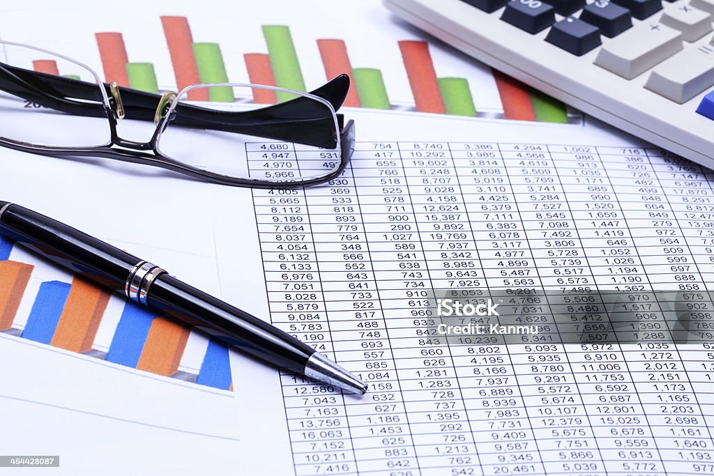 financial results Pen, calculator and financial reports Analyzing Stock Photo