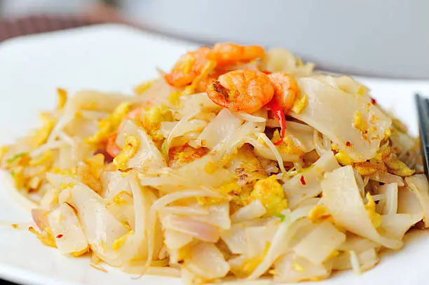 stir fried chinese flat rice flour noodles with shrimp and vegetables