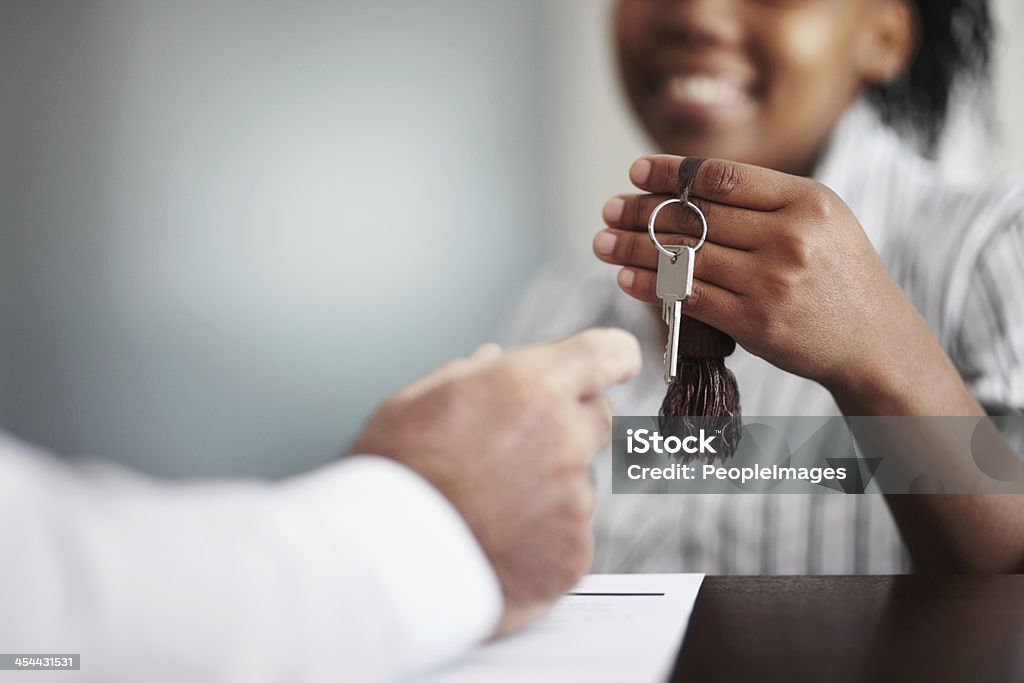 Let me know if everything is to your satisfaction... Closeup of a receptionist handing over the hotel room keys to a senior patron Hotel Stock Photo