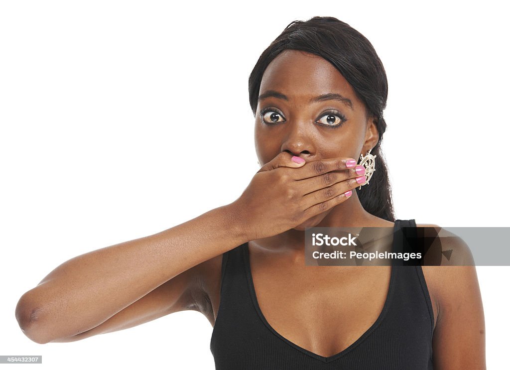 I can't believe she said that! Shocked young woman covering her mouth while isolated on white 20-24 Years Stock Photo