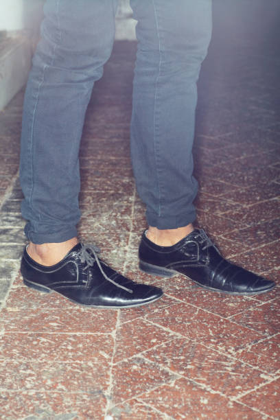 Cropped view of a man legs standing on brick