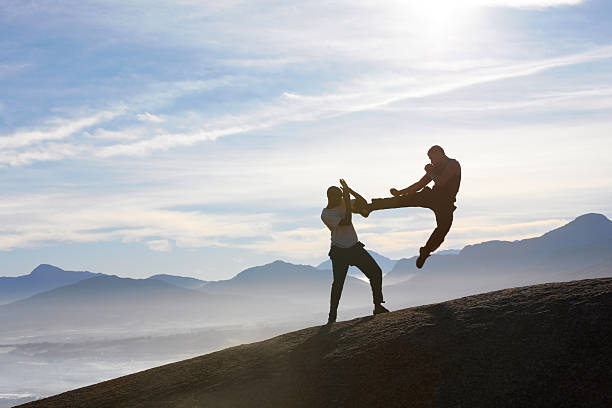 istock Two male kickboxers fighting on a mountain top 454438945