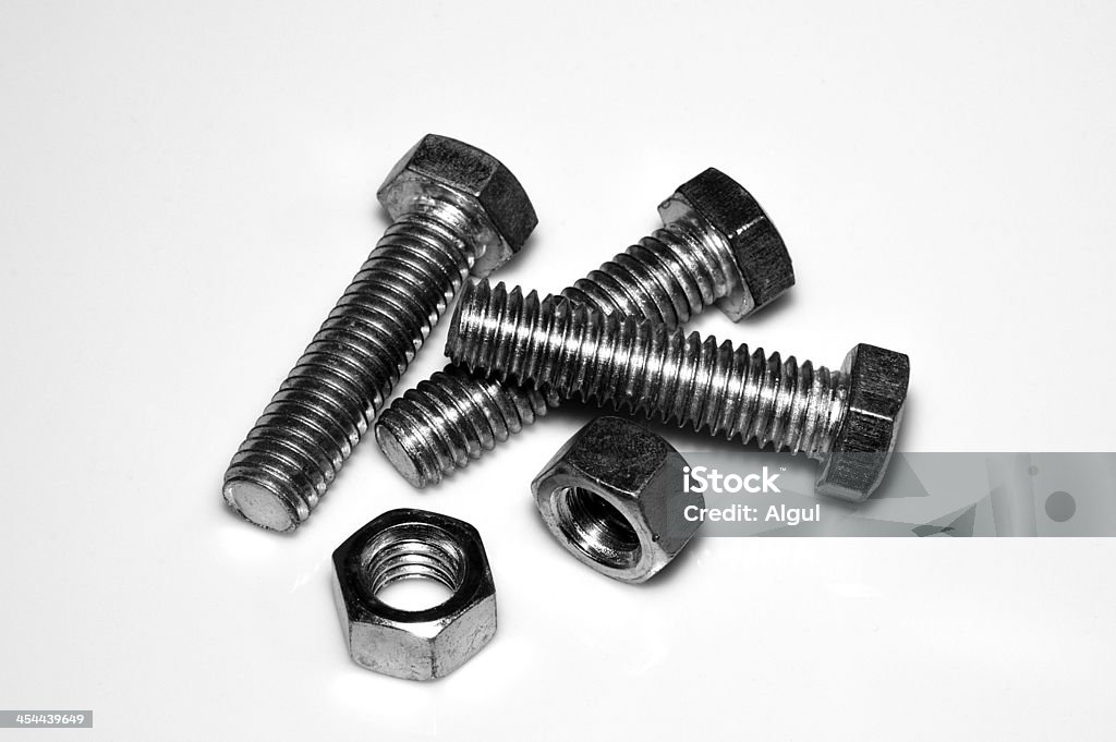 Bolts and nuts Steel bolts and nuts on white background close-up. B&W Alloy Stock Photo