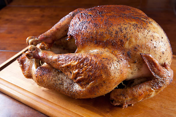 Roasted Turkey Resting on Wooden Board stock photo