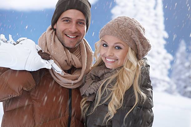 istock Happy couple going ice skating in snowfall 454890639