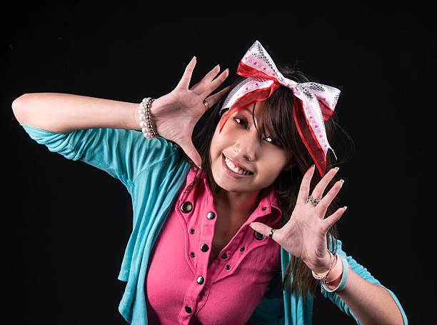An image of an Asian girl in the studio against a black background
