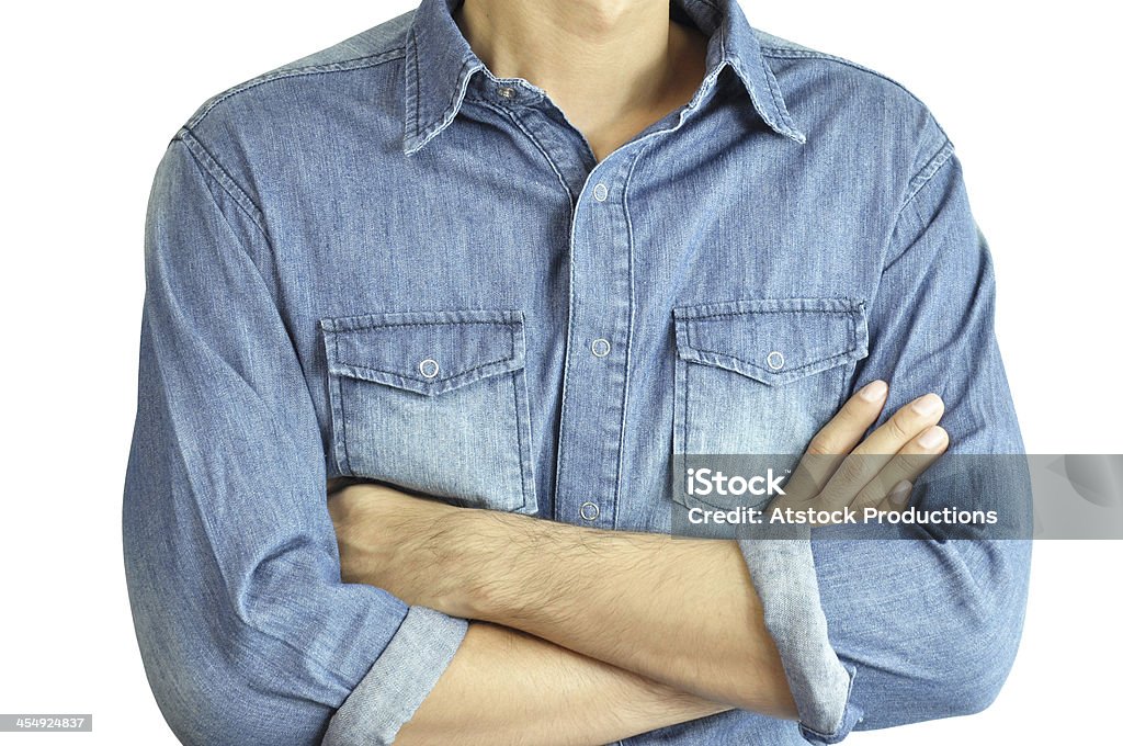 Man wearing jean shirt crossing his arms A man with jean shirt crossing his arms on white background Adult Stock Photo