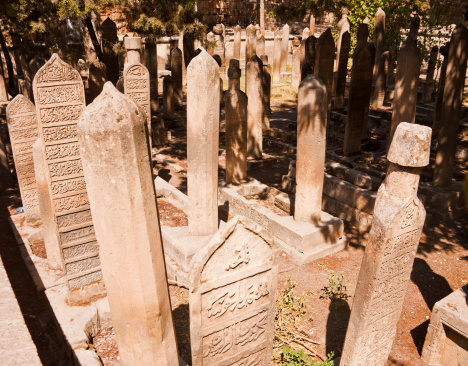 Intricate islamic writings on tombstones in the islamic graveyard of a famous mosque in Sanliurfa, Turkey.