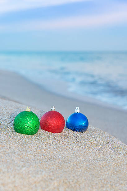 istock Christmas tree decorations on sea coast 454930515