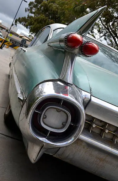 Shot of the left side tail fin and rear of a classic car.