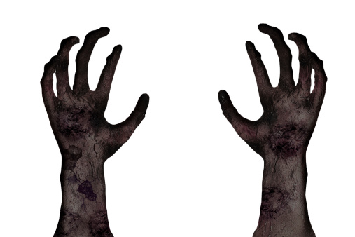 Close-up of zombie's hands on white background