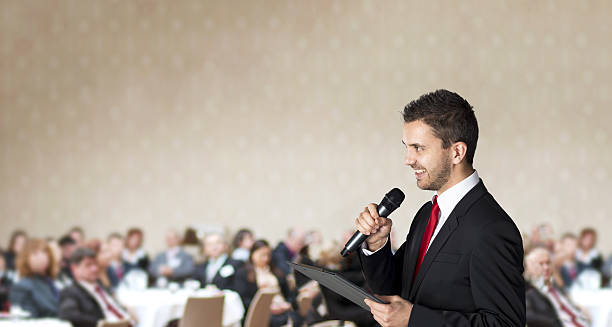 istock Man in suit talking at a business conference 454937467