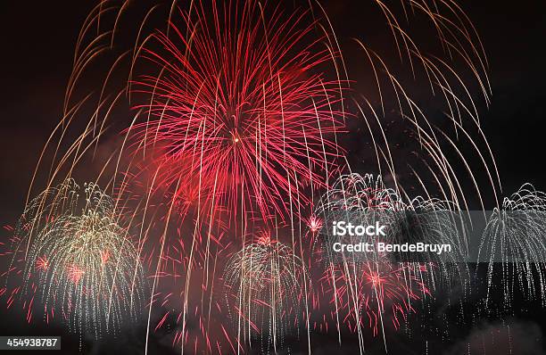 Fireworks And Bright Red Colors Dancing In The Sky Stock Photo - Download Image Now - Black Color, Bronze - Alloy, Bronze Colored