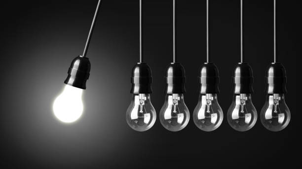 istock Six lightbulbs, one lit, in the form of Newton's cradle 454943883
