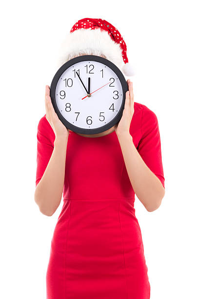 istock woman in santa hat with clock posing isolated on white 454947585