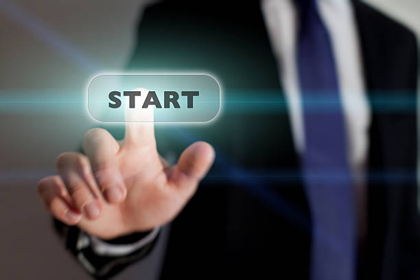 istock Businessman pressing a start icon on a transparent screen 454948249