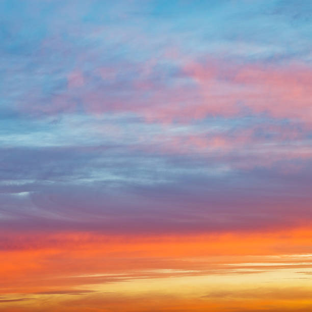 istock pastel pink and yellow sunrise clouds in blue sky 454953183
