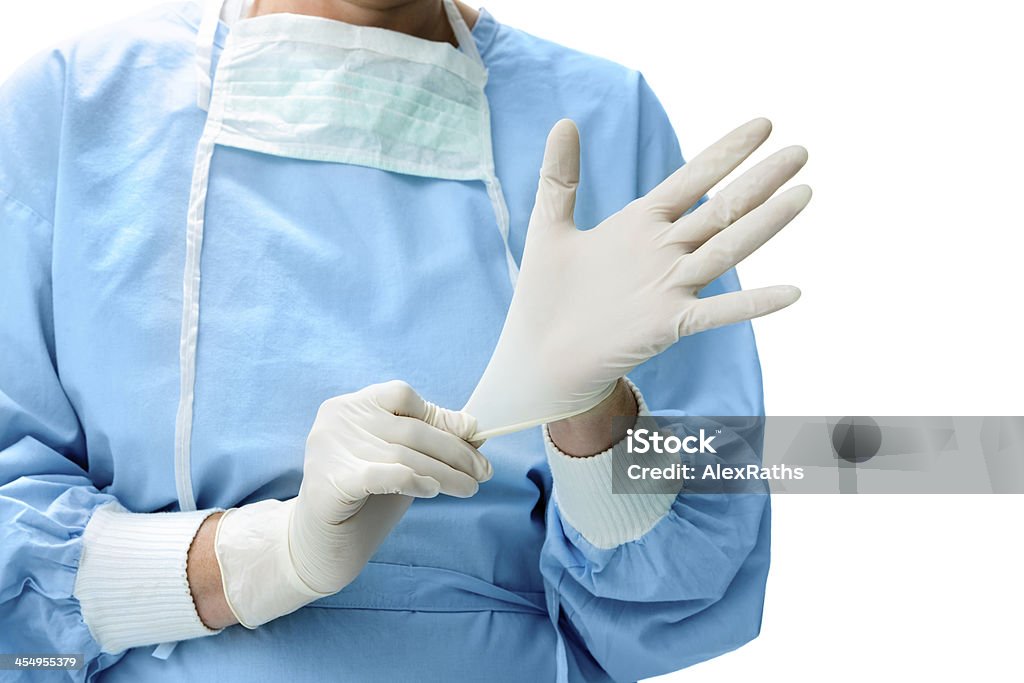 Doctor putting on medical gloves Doctor putting on white sterilized surgical glove Assistance Stock Photo
