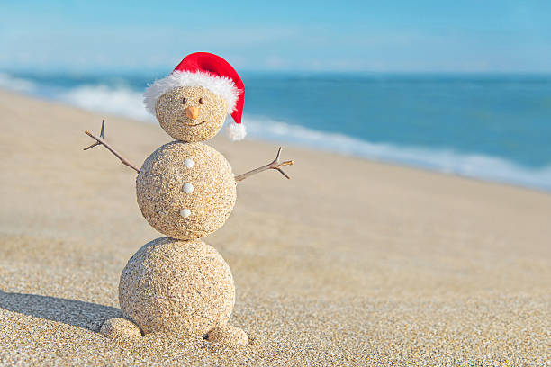 istock Happy Christmas snowman made from sand wearing santa hat 454955633