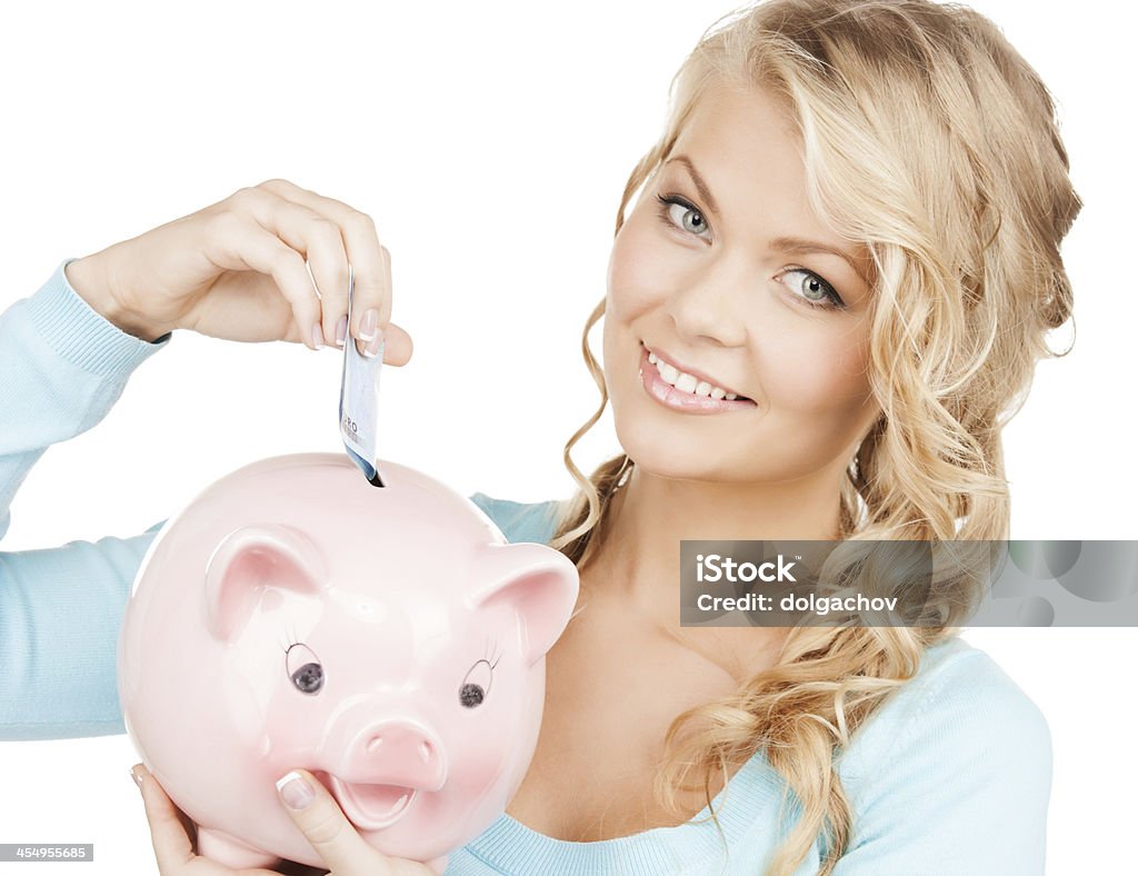 woman puts cash money into big piggy bank buisness, banking and savings concept - happy businesswoman puts cash money into big piggy bank Currency Stock Photo