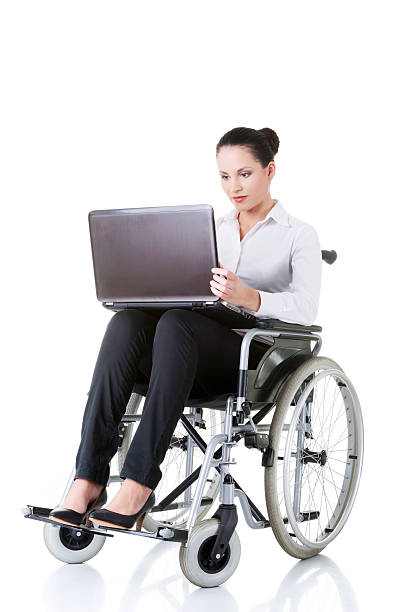 Young business woman sitting on a wheelchair. stock photo