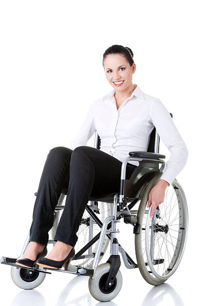 Young business woman sitting on a wheelchair. stock photo