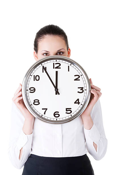 istock Young business woman holding a clock. 454956149
