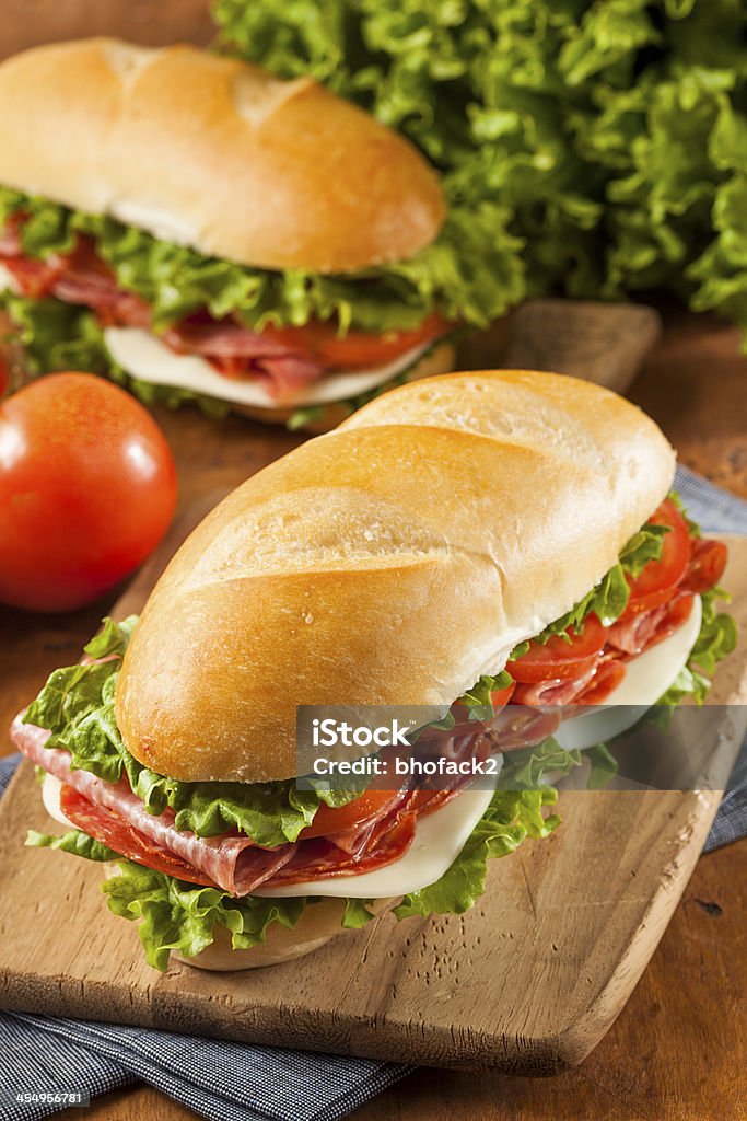 Homemade Italian Sub Sandwich Homemade Italian Sub Sandwich with Salami, Tomato, and Lettuce Submarine Stock Photo