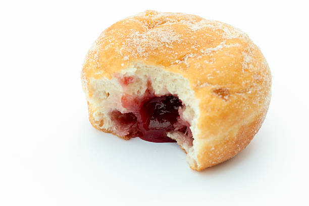 Jam donut Jam doughnut with a mouthful taken out and jam showing, on a white background Jam Doughnut stock pictures, royalty-free photos & images